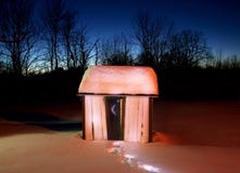 snow-covered-glowing-outhouse-18415808.jpg
